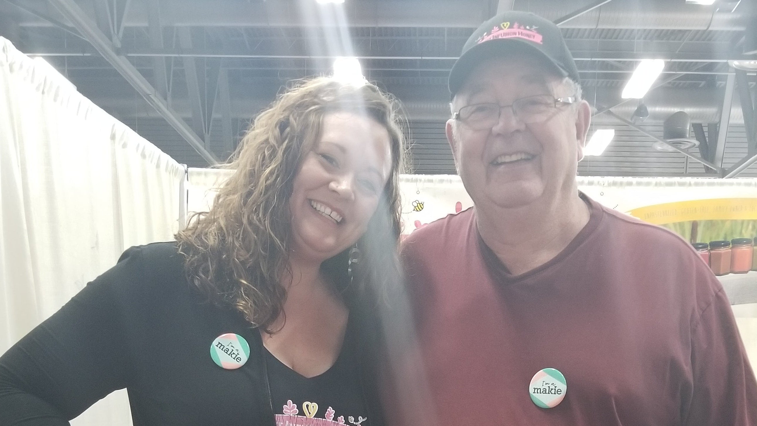 Two people standing together with a bright light source in the foreground.